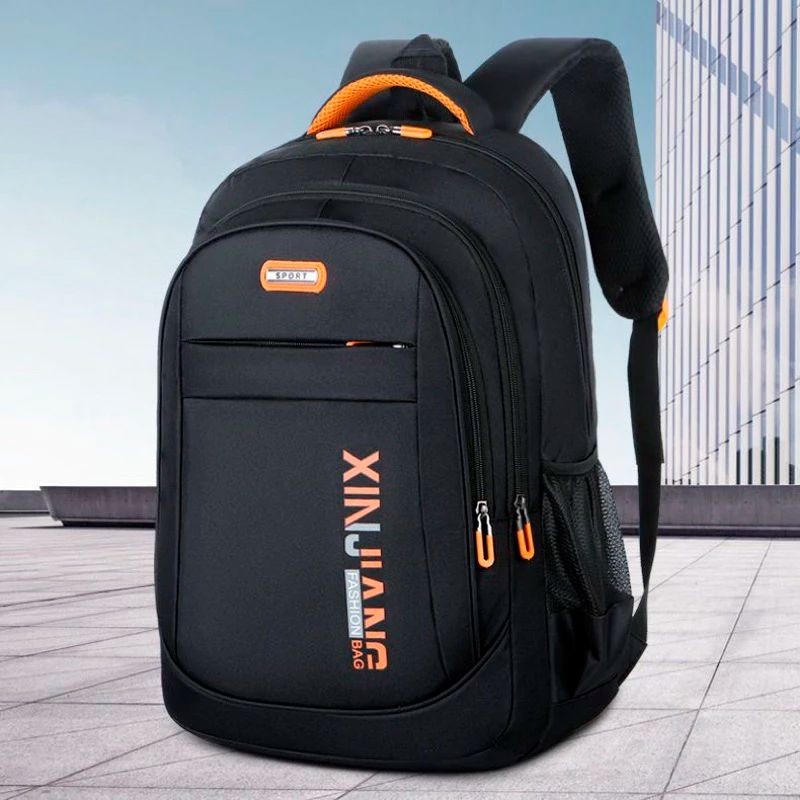 Black and orange sport backpack on a city plaza backdrop with glass building.