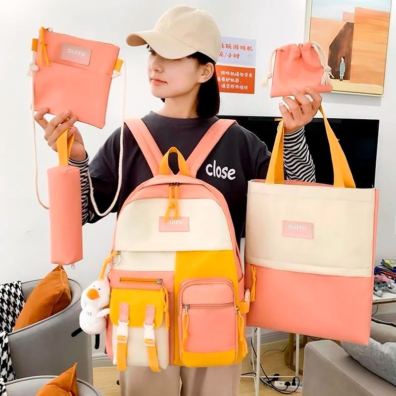 Person holding and wearing a set of pink and yellow bags with various compartments.